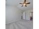Bedroom featuring a ceiling fan, neutral carpet, and doorway to bathroom at 13410 Tartarian Ct, Charlotte, NC 28215