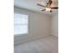A cozy bedroom featuring neutral walls, carpet flooring, and a ceiling fan for added comfort at 13410 Tartarian Ct, Charlotte, NC 28215