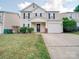 Charming two-story home with a well-manicured lawn and inviting front entrance with a storm door at 13410 Tartarian Ct, Charlotte, NC 28215