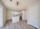 Bright kitchen with an island, white cabinets, and stainless steel appliances with lots of natural light at 13410 Tartarian Ct, Charlotte, NC 28215