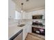 Modern kitchen featuring white cabinets, quartz countertops and stainless appliances at 13410 Tartarian Ct, Charlotte, NC 28215