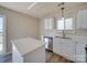 Well-lit kitchen with a stainless steel dishwasher and ample countertop space at 13410 Tartarian Ct, Charlotte, NC 28215