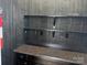 Stylish bar area with granite countertop, storage cabinets, and rustic black wooden paneling at 135 Waycross Dr, Rockwell, NC 28138