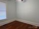 A light-filled room features light-blue walls, crisp white trim, and gleaming wood floors at 135 Waycross Dr, Rockwell, NC 28138