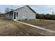 Exterior view of home featuring a covered porch and large backyard at 135 Waycross Dr, Rockwell, NC 28138