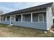 Charming home featuring a covered porch with white pillars and gray siding at 135 Waycross Dr, Rockwell, NC 28138