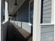 Covered front porch with wood-look tile flooring and natural light perfect for outdoor entertaining at 135 Waycross Dr, Rockwell, NC 28138