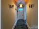 Hallway featuring tiled floor, wooden ceiling and a white front door at 135 Waycross Dr, Rockwell, NC 28138