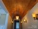 Hallway features a unique wood-paneled ceiling, elegant lighting fixtures and neutral wall colors at 135 Waycross Dr, Rockwell, NC 28138