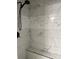 Modern shower featuring marble-style tiling and a built-in bench at 135 Waycross Dr, Rockwell, NC 28138