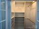 The walk-in closet has wire baskets, shelves, and wooden closet rods for organization at 135 Waycross Dr, Rockwell, NC 28138