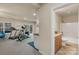 Finished basement with kitchenette, exercise equipment, and adjoining bathroom at 14104 Green Birch Dr, Pineville, NC 28134
