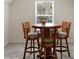 The breakfast nook boasts a wooden table, barstools, and bright natural light at 14104 Green Birch Dr, Pineville, NC 28134