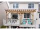 Back deck offers a cozy space for outdoor dining with its stylish pergola and comfortable seating at 14104 Green Birch Dr, Pineville, NC 28134