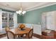 Elegant dining room featuring a round table, chandelier, and wainscoting, perfect for hosting gatherings at 14104 Green Birch Dr, Pineville, NC 28134