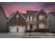 Charming two-story brick home featuring a two-car garage and inviting front entrance at 14104 Green Birch Dr, Pineville, NC 28134
