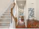 Bright foyer with hardwood floors, staircase, and a view of the living room, creating a welcoming entrance at 14104 Green Birch Dr, Pineville, NC 28134
