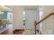 Bright foyer featuring hardwood floors, a staircase, and an open view, creating a welcoming ambiance at 14104 Green Birch Dr, Pineville, NC 28134