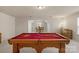 Spacious game room boasts a red pool table, neutral paint, and bright natural light at 14104 Green Birch Dr, Pineville, NC 28134