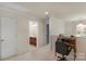 Hallway features a small desk, vanity, door, and neutral decor in this two-story home at 14104 Green Birch Dr, Pineville, NC 28134