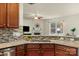 Open kitchen featuring granite counters, stainless steel sink, and view to living room at 14104 Green Birch Dr, Pineville, NC 28134