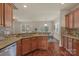 Well-lit kitchen with granite countertops, hardwood floors, and an open view into the adjacent dining area at 14104 Green Birch Dr, Pineville, NC 28134