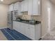 Kitchenette featuring white cabinetry, granite countertops, and stainless steel appliances at 14104 Green Birch Dr, Pineville, NC 28134