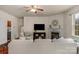 Large living room with fireplace, hardwood flooring, and easy access to other rooms at 14104 Green Birch Dr, Pineville, NC 28134