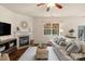Comfortable living room featuring a fireplace, hardwood floors, and natural light at 14104 Green Birch Dr, Pineville, NC 28134