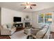 Cozy living room with fireplace, hardwood floors, and large windows at 14104 Green Birch Dr, Pineville, NC 28134