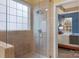 Tile shower boasts glass door and window letting in natural light, located inside the main bathroom at 14104 Green Birch Dr, Pineville, NC 28134