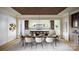 Bright dining room with a spacious table set for six beneath an elegant decorative wood paneled ceiling at 1437 Samuel Spencer Pkwy, Davidson, NC 28036