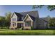 Charming two-story home with brick facade, manicured lawn and colorful shrubbery under a sunny sky at 1437 Samuel Spencer Pkwy, Davidson, NC 28036