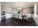 Bright dining room featuring decorative walls, wainscoting, and a stylish chandelier at 15416 Cimarron Hills Ln, Charlotte, NC 28278