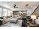 Open-concept living room with a large sectional sofa and adjacent modern kitchen at 15416 Cimarron Hills Ln, Charlotte, NC 28278