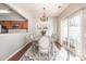 Elegant dining room with chandelier, wood floors, and natural light, ideal for gatherings at 15562 Canmore St, Charlotte, NC 28277