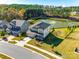 Aerial view of the home showcasing its location near a pond with a fountain and wooded area at 16216 Kelby Cv, Charlotte, NC 28278