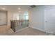 Upstairs hallway with carpeted flooring and railing at 166 Swann Rd # 5, Statesville, NC 28625