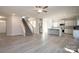 Open living room and kitchen with grey vinyl flooring and stainless steel appliances at 166 Swann Rd # 5, Statesville, NC 28625