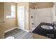 Well-lit bathroom with a granite vanity top, shower and tub combination at 184 Fairhill Rd, Heath Springs, SC 29058