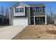 Two-story home featuring gray siding, blue shutters, a two-car garage, and a well-manicured lawn at 214 Brinkley Dr # 9, Kings Mountain, NC 28086