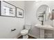 Elegant powder room with pedestal sink and modern fixtures at 2320 Donnelly Hills Ln, Charlotte, NC 28262
