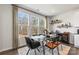 Bright dining area with glass table and modern chairs, overlooking wooded area at 2320 Donnelly Hills Ln, Charlotte, NC 28262