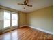 Bedroom with hardwood floors, a ceiling fan, and large windows for plenty of natural light at 387 Ridge Rd, Clover, SC 29710