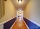 Hallway with hardwood floors, blue accent walls, and recessed lighting at 387 Ridge Rd, Clover, SC 29710