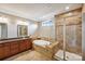 Elegant bathroom with granite counters, soaking tub, and glass-enclosed shower at 4027 Wiltshire Ln, Indian Land, SC 29707