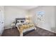 Bright bedroom featuring a large window, neutral paint, and stylish bedding at 4027 Wiltshire Ln, Indian Land, SC 29707