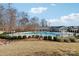Inviting community pool surrounded by manicured landscaping, a clubhouse, and comfortable seating for residents at 4027 Wiltshire Ln, Indian Land, SC 29707