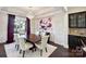 Formal dining room with a chandelier, floral wallpaper, and a dark wood table with cream upholstered chairs at 4027 Wiltshire Ln, Indian Land, SC 29707