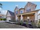 Beautiful two-story home featuring stone and siding details, a covered porch, and manicured landscaping at 4027 Wiltshire Ln, Indian Land, SC 29707
